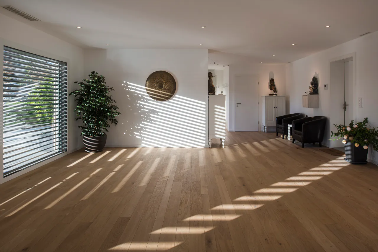 Sunlight crossing the wooden floor of the UNITY studio at Domaine du Village