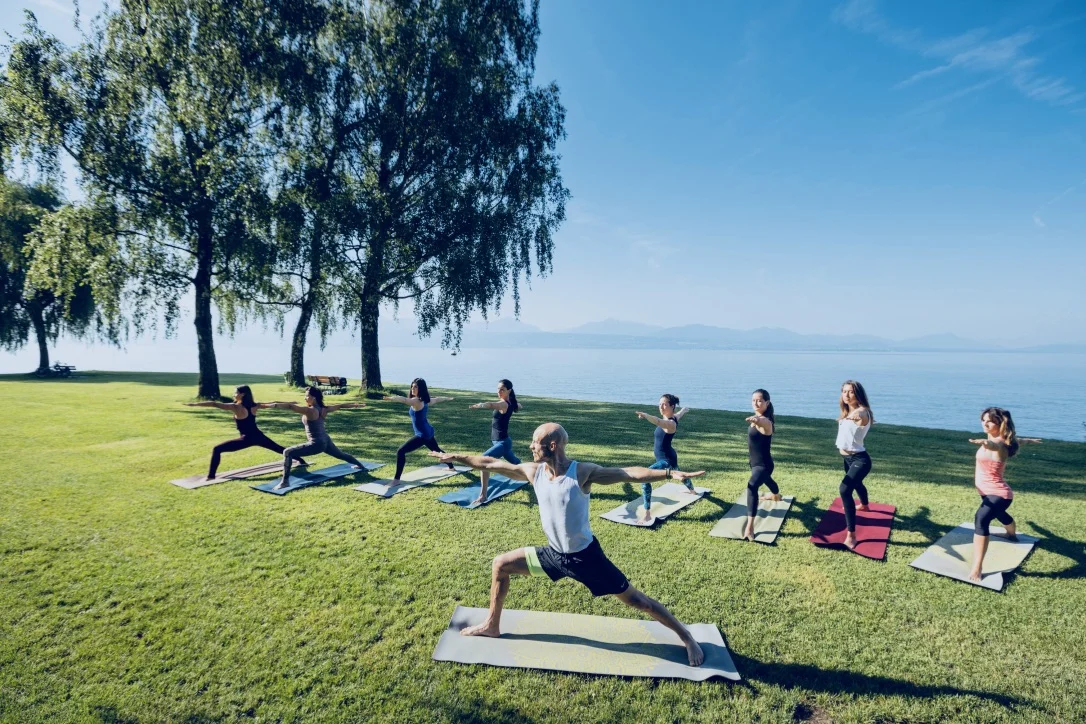 UNITY group practising yoga beside Lake Geneva