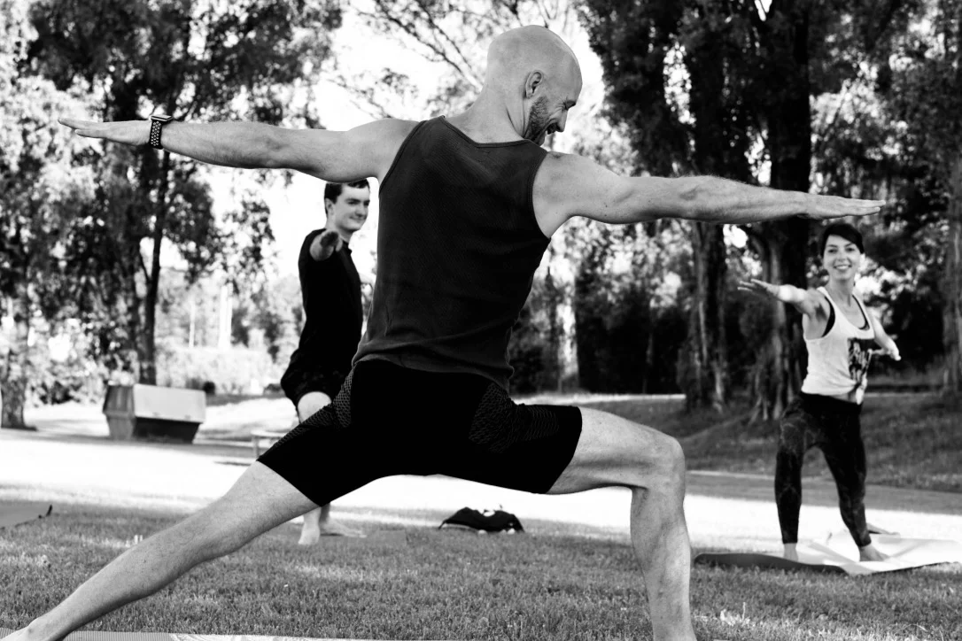 A yoga posture being taught during a UNITY class beside Lake Geneva