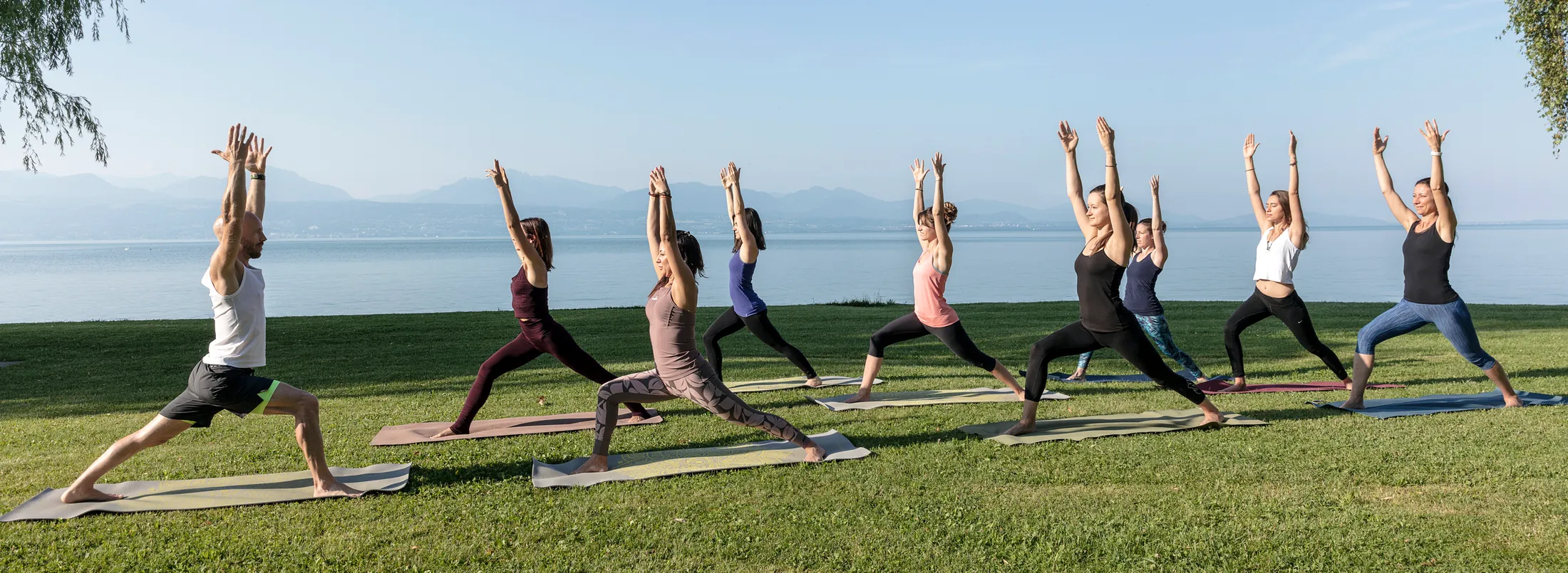 Felix leads a UNITY group yoga class beside Lake Geneva