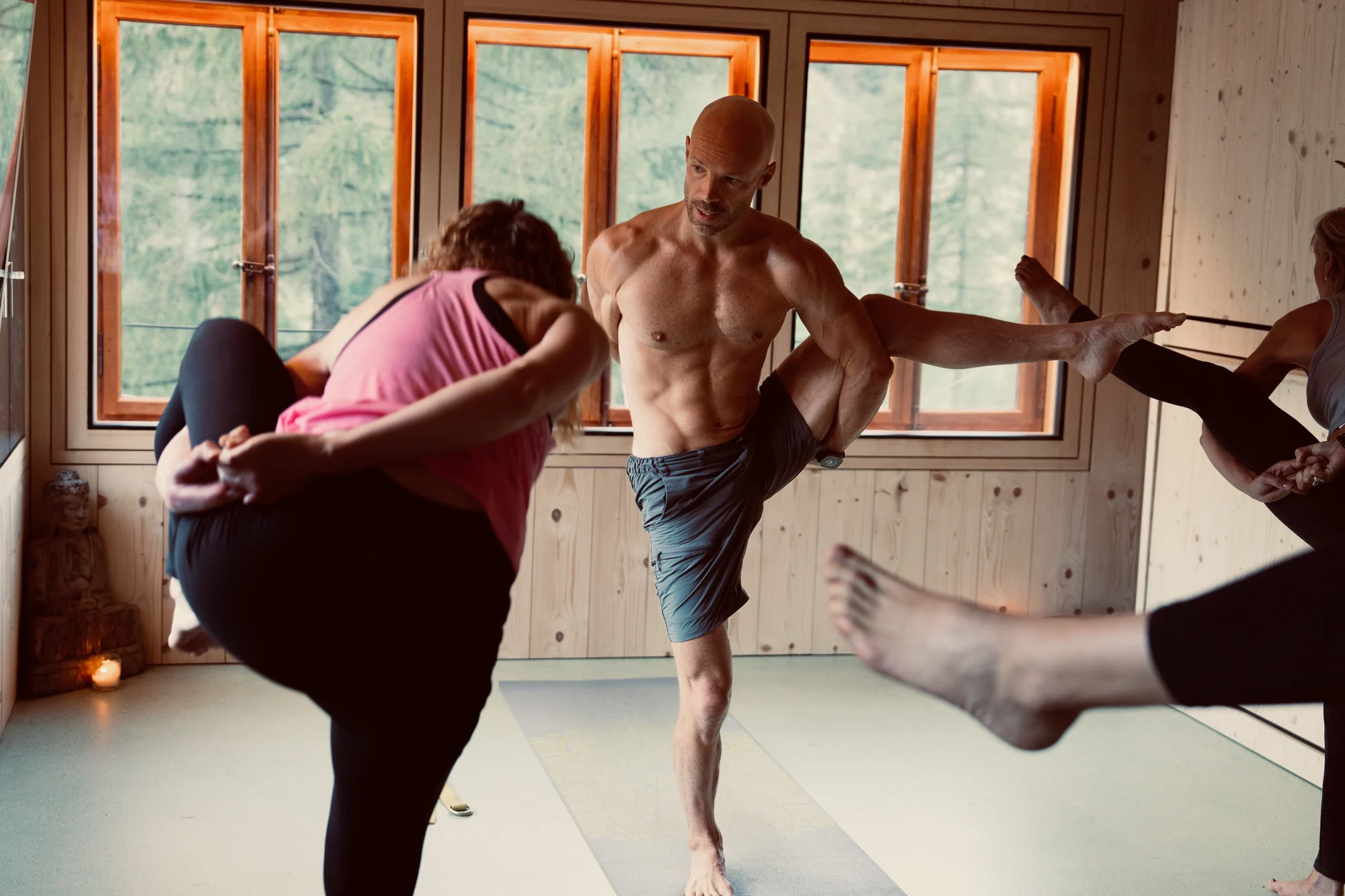 Felix balances in Bird of Paradise with the arms bound around the lifted thigh and the raised leg extending sideways.