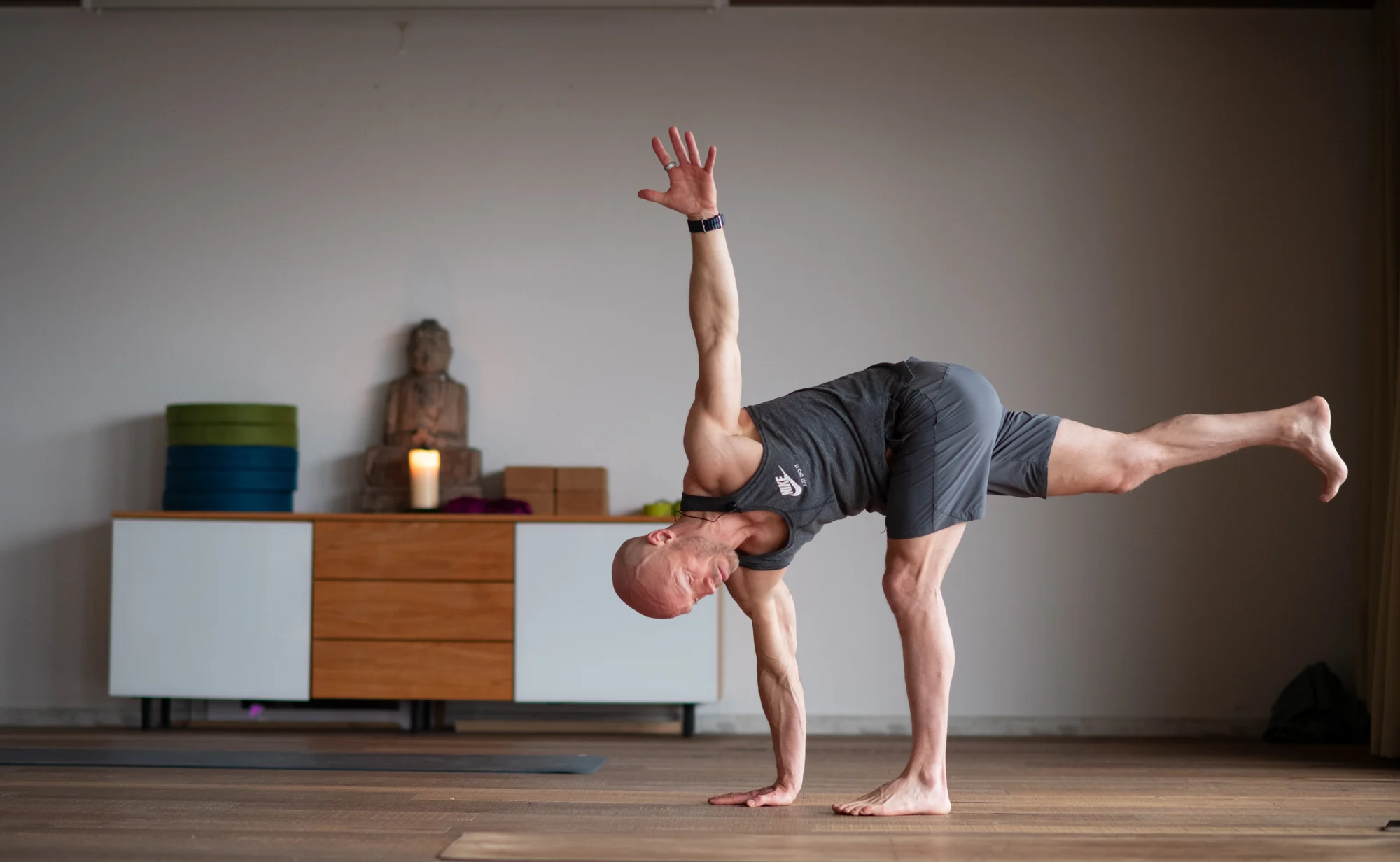 Felix balances in Half Moon with one hand on the floor, the chest open sideways and the raised leg extended behind.