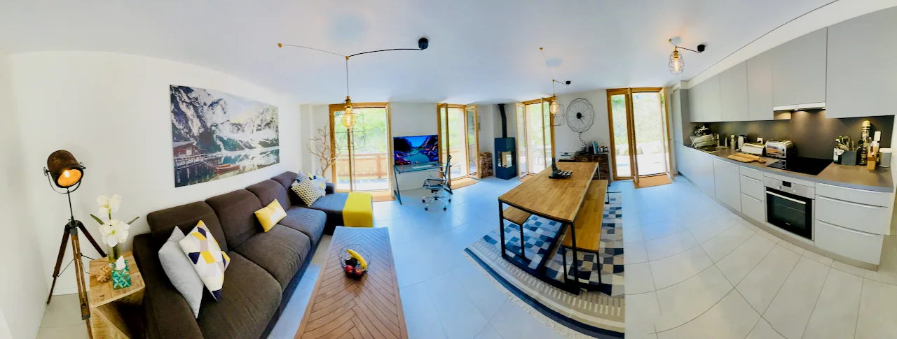 Open-plan living room and kitchen in the private Les Mosses chalet flat