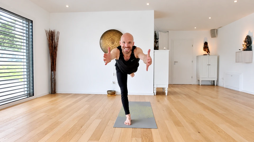Felix demonstrating a balancing yoga pose facing the camera